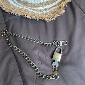 LV louis vuitton silver and gold lock and key. Used as necklace.